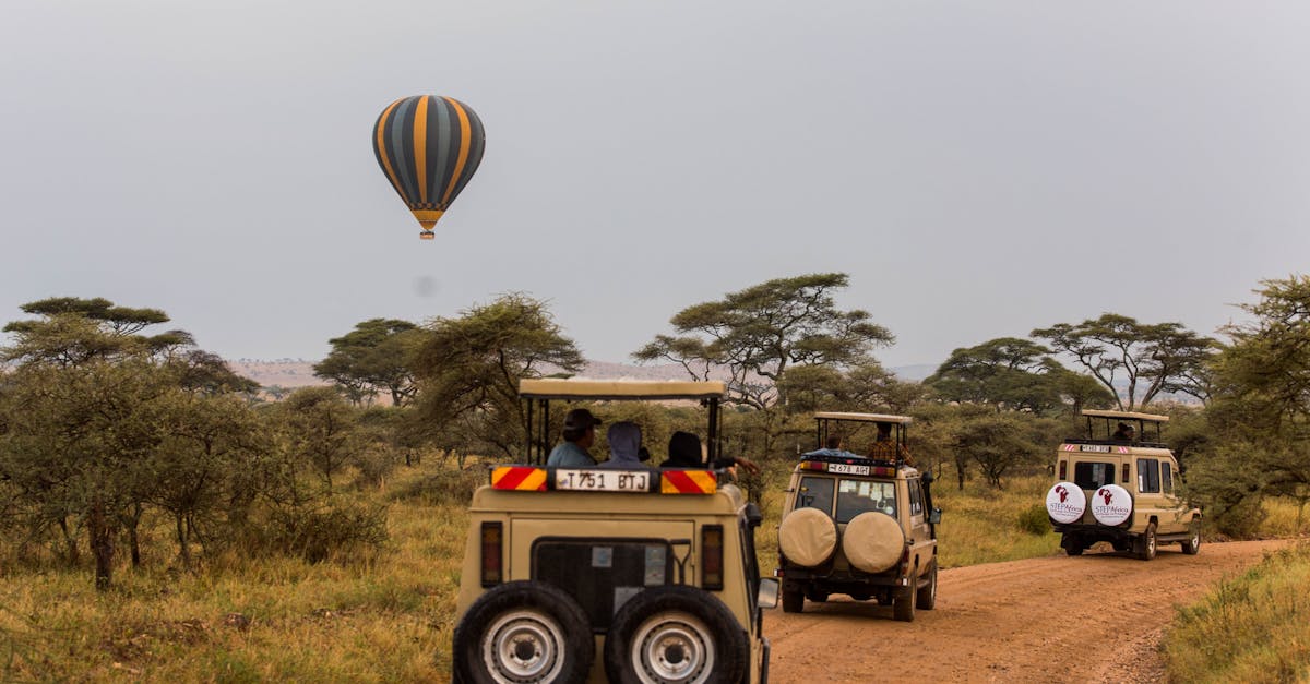Scenic safari adventure in Tarangire with off-road vehicles and a hot air balloon in the savannah.