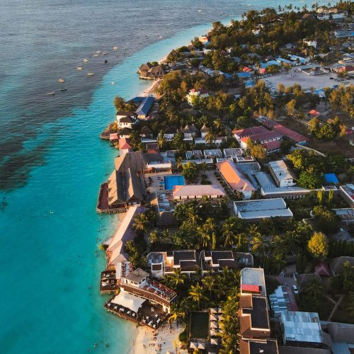 Stunning aerial view of Nungwi beach in Zanzibar showcasing turquoise waters and lush resorts.